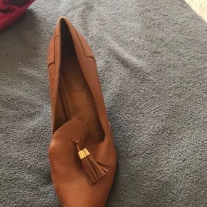 Light brown pointy heels with  gold tassel